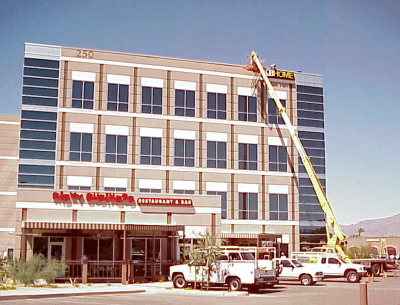 Addisigns Crane Installing Building Sign - Addisigns sign installation Tucson