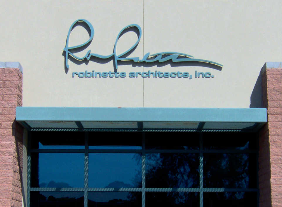 Robinette Architects, Inc Reverse Pan Channel Letters on a beige wall.
